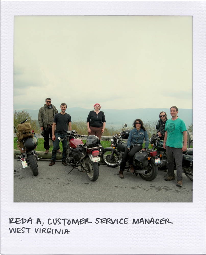 Polaroid photo shows 4 motorcycles parked at the edge of a road overlooking some foggy mountains. Pictured is Motomentum's Reda, sitting on her motorcycle in a denim jacket, among 3 other friends &amp; her husband, Chuck