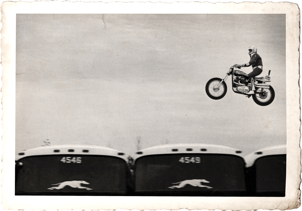 black and white photo of Evel Knievel jumping several Greyhound busses