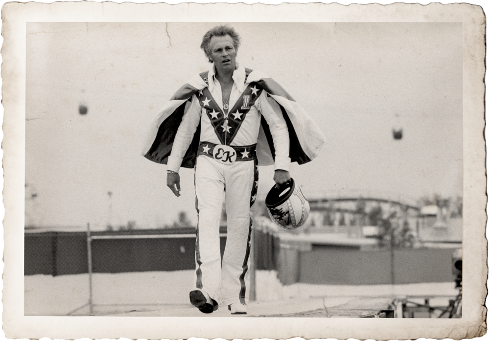 black and white photo of Evel Knievel walking in costume before a performance