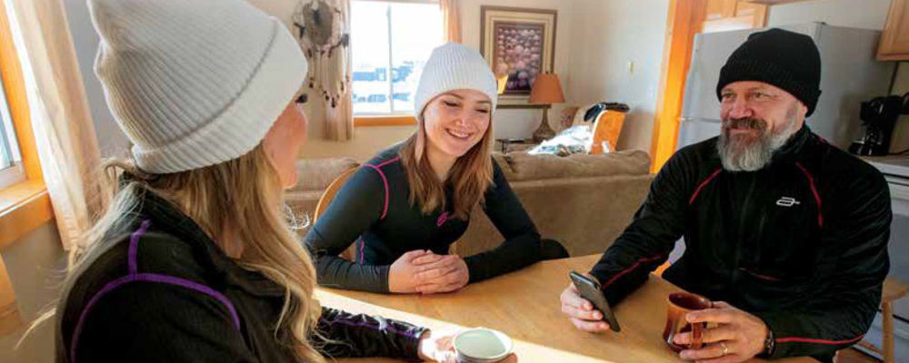 Friends gathering in a living room wearing base layer clothing