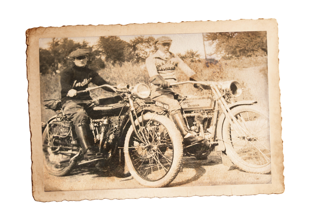 An old photograph depicting an Indian motorcycle and a Harley-Davidson motorcycle