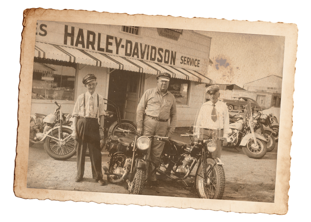 An old photograph depicting a Harley-Davidson dealership in the early 1900s
