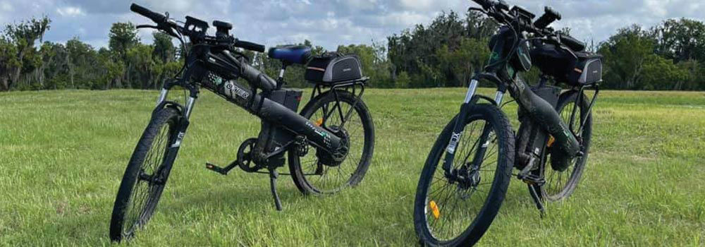 Two Ecotric eBikes in a field of grass